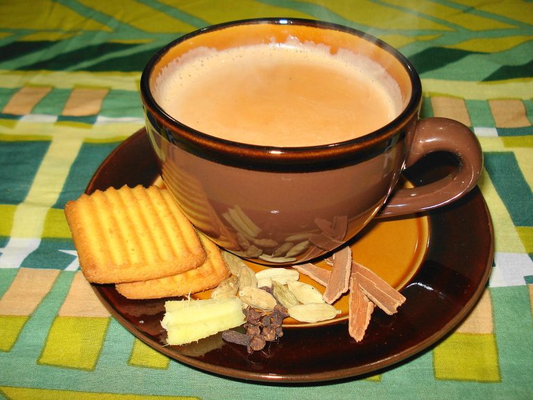 Tasse de chai au lait épicé, servie avec des biscuits